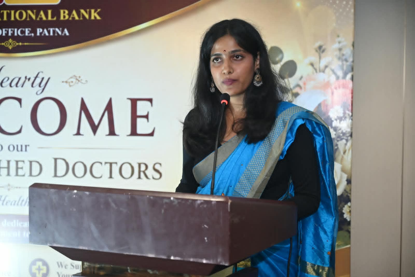 Woman speaking at a podium during an event